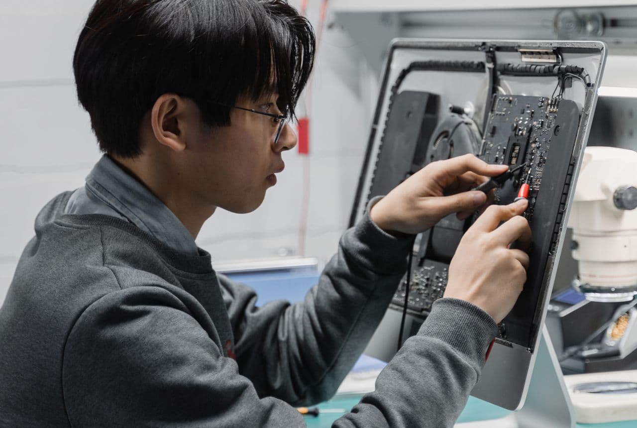 Certified NexaFix technicians repairing a device in Dubai