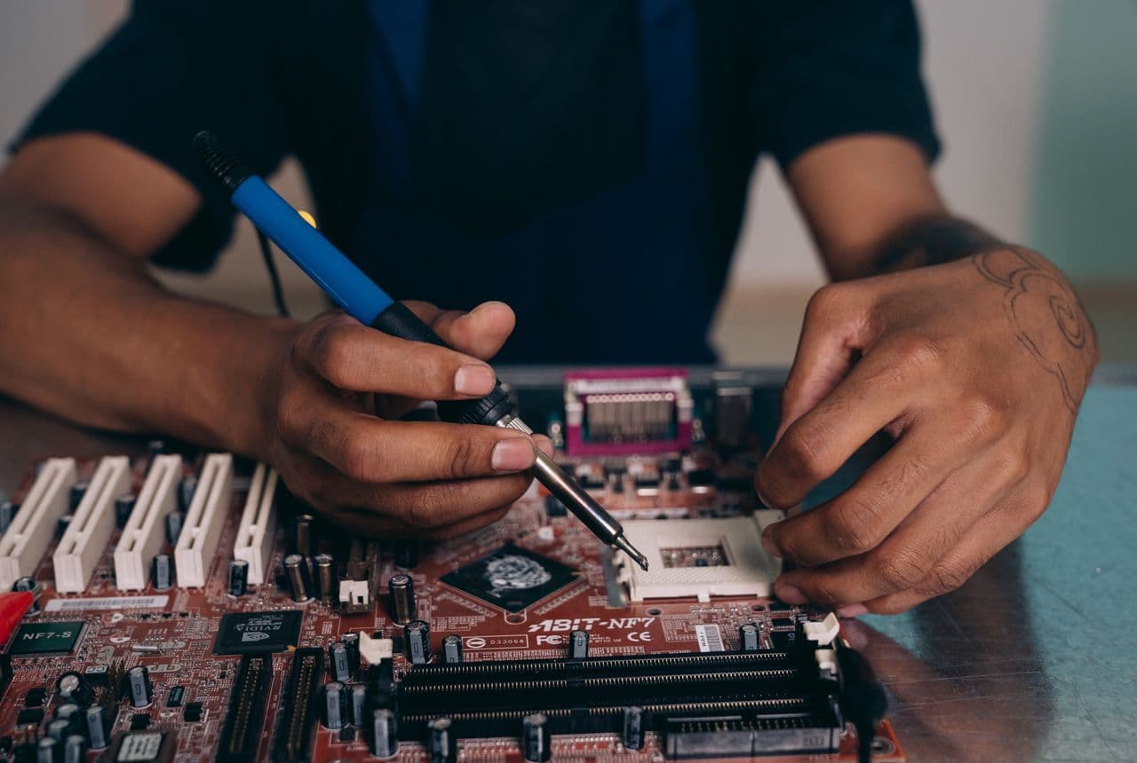 Board-level device repair at a NexaFix workbench in Dubai