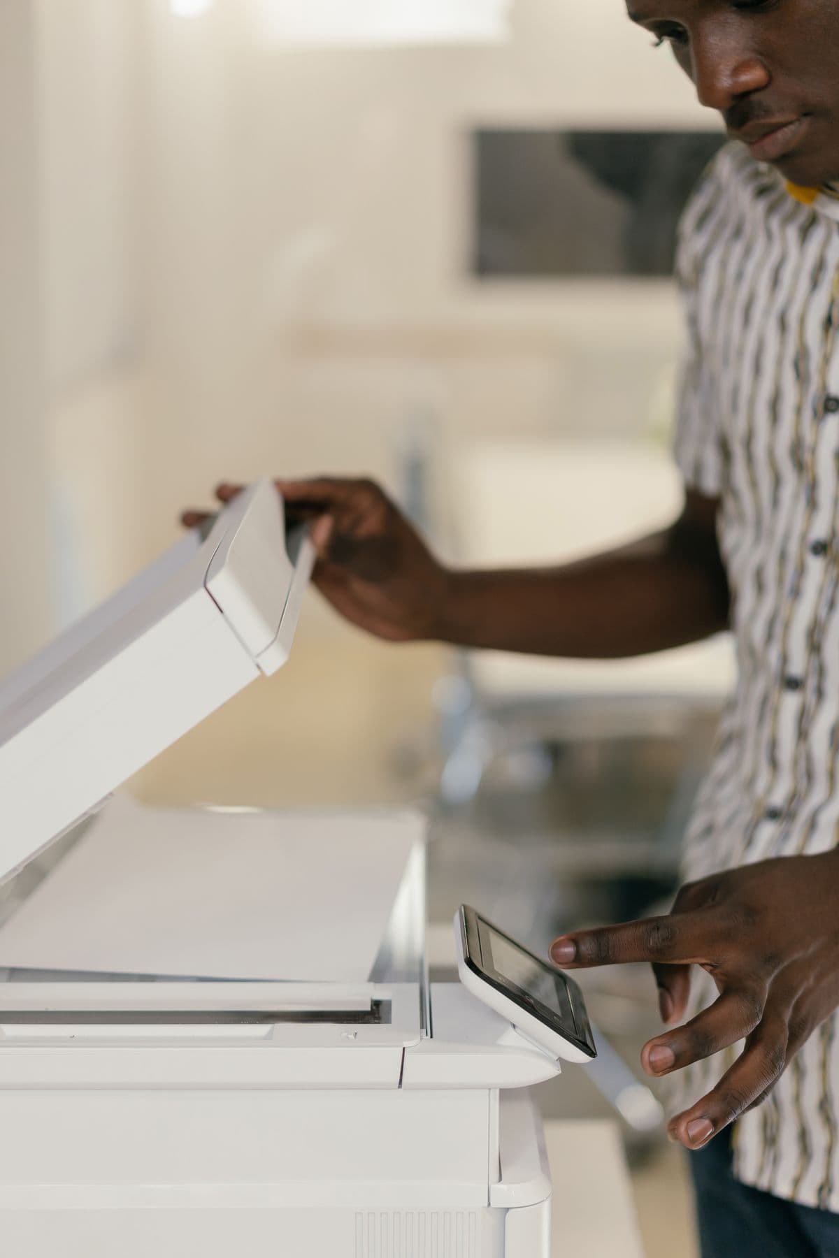 Employee operating a multifunction office copier