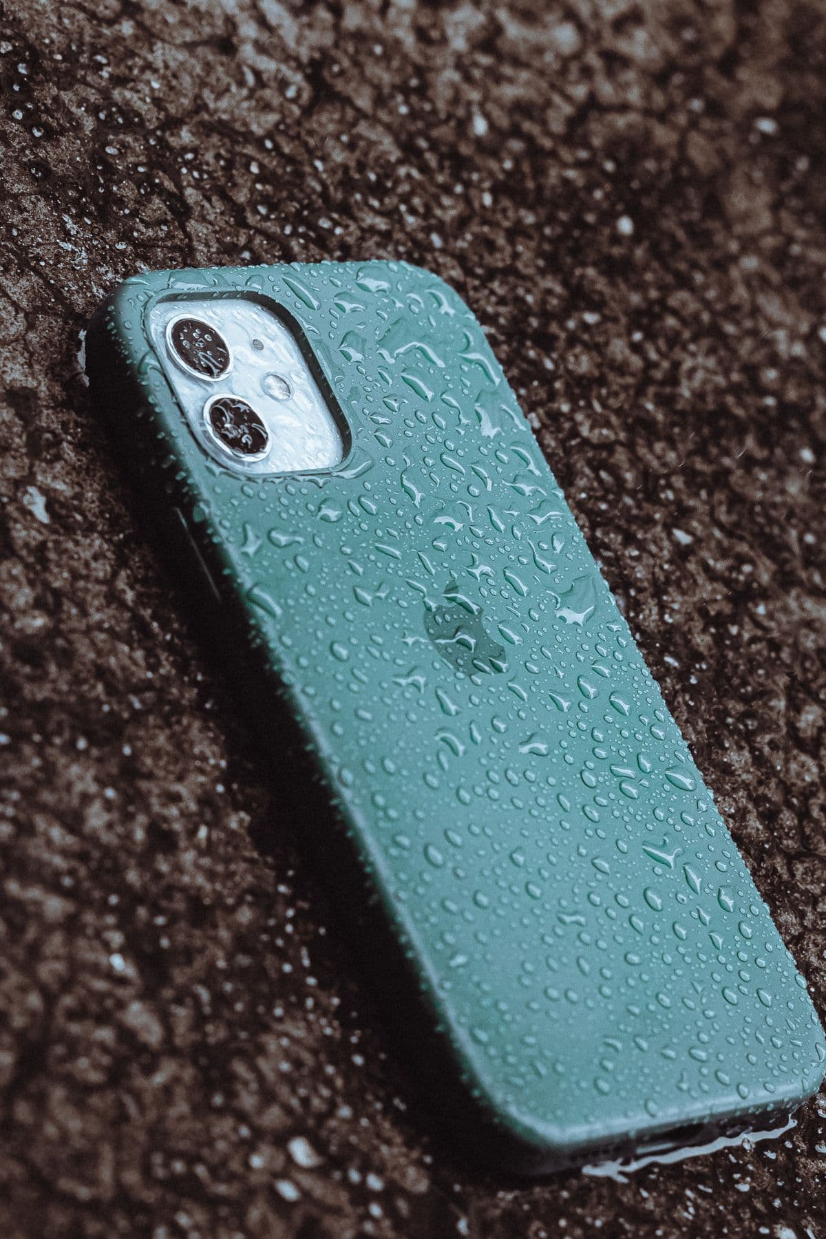 Smartphone covered in water drops after liquid exposure