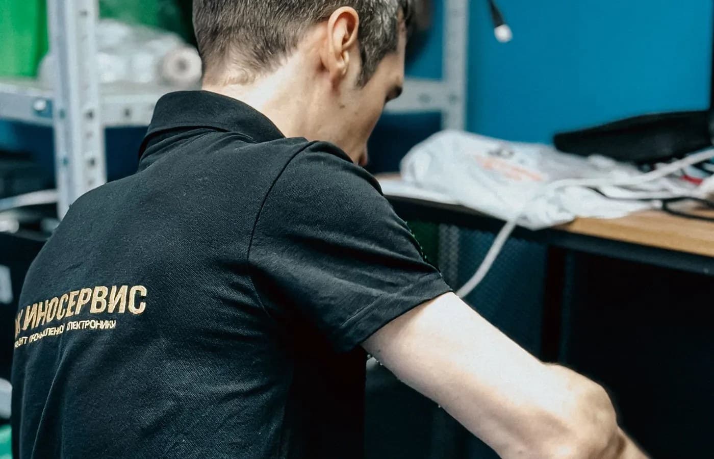 Technician servicing computer equipment in a modern repair workspace