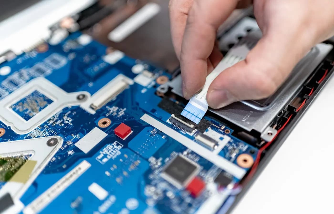Close-up of laptop components during a professional hardware upgrade