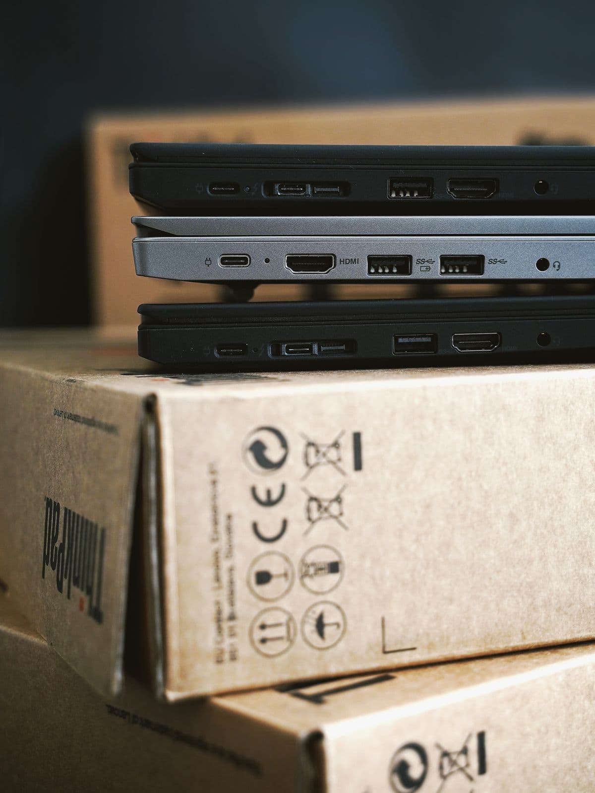 Windows laptops stacked for service with ports visible